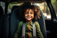 Little African American Girl In A Child Car Seat Wearing A Seatbelt While Traveling By Car.