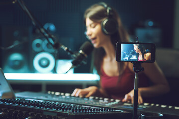 Young artist recording a song and streaming a video