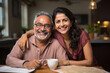 © StockImageFactory - Portrait of Indian happy couple embracing each other at home on sofa or dining table