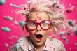 Enchanting portrait of a curly-haired girl with tousled blond locks, donning multicolored strands and glasses, exuberantly captured in a joyful scream on the vibrant pink background.