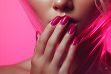 woman with beautiful hand with pink nails , with pink background