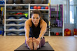 © Mat Hayward - Healthy woman stretching her legs in the gym during a workout.