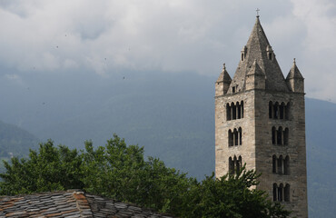 Wall Mural - The collegiate church of Santi Pietro e Orso is a Romanesque religious complex in Aosta; the bell tower and the ancient cloister are beautiful in Aosta Valley.