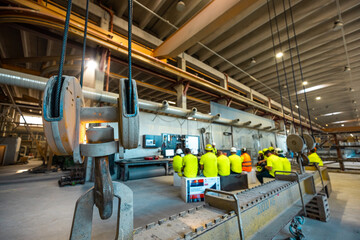 Skillful worker attending brief meeting in the factory . Industrial people and manufacturing labor concept