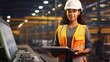 © David - African American female worker in safety uniform and helmet is checking system machines with laptop in the factory. woman in the big manufacturing industry.
