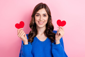 Poster - Photo portrait of lovely young lady hold two little red hearts postcards dressed stylish blue garment isolated on pink color background