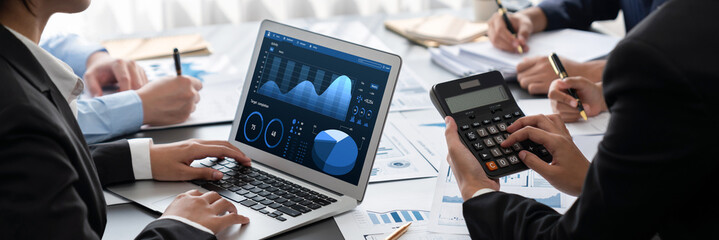 Business intelligence and data analysis concept. Analyst team working on financial data analysis dashboard on laptop screen as marketing indication for effective business strategic planning. Insight