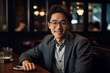 © Surachetsh - Handsome man with a happy face sitting and smiling with a confident smile showing teeth. Portrait of young man smiling. Young Asian man sitting at coffee shop. Generative AI.