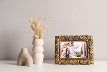 Vintage Square Frame With Family Photo And Other Decor Elements On White Table