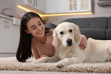 Sticker - Happy woman with cute Labrador Retriever dog on floor at home. Adorable pet