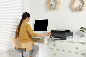 Poster - Woman using modern printer at workplace indoors