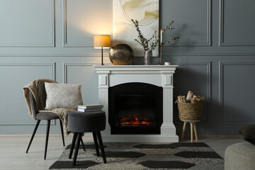 Canvas Print - Beautiful fireplace, different decor, firewood and armchair in living room. Interior design