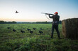 © Sergey - Hunter man with a gun hunting on black grouse at beautiful sunrise. The man is on the hunt. Hunter man.