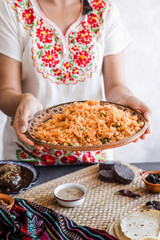 Wall Mural - Mexican woman cooking red rice with ingredients, traditional food in Mexico Latin America
