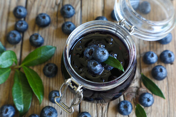 Wall Mural - Blueberry jam in jar with berries and leaves