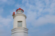 The top part of a lighthouse against the sky.
