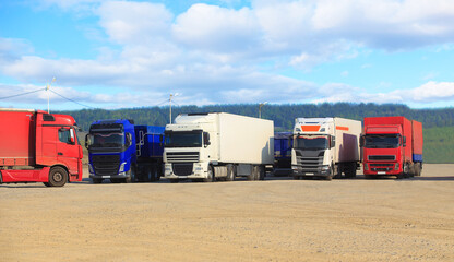 Canvas Print - Trucks in a parking lot outside the city