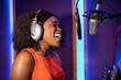 © ADDICTIVE STOCK - Black woman singing and creating song