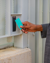 Black businessman entering door with keycard
