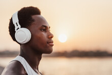 Black Man Listening To Music In Headphones Near Water