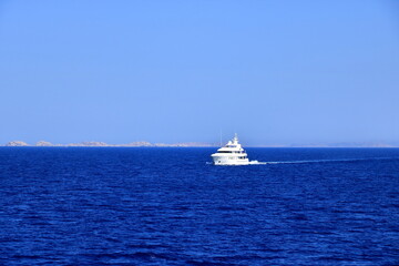 Wall Mural - Boat in front of Bonifacio beacon , Corsica, France