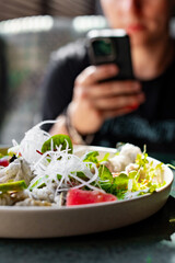 Wall Mural - Fresh sashimi salad with salmon fish, tuna and vegetables on table