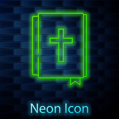 Poster - Glowing neon line Holy bible book icon isolated on brick wall background. Vector