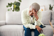 © Chanelle Malambo/peopleimages.com - Woman, depression and headache in home for anxiety, mental health and stress of mistake, debt or crisis. Tired, sad and frustrated african person with emotional trauma, broken heart and worry on sofa