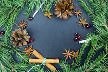 Christmas Background Set With Fir-tree Branches, Cones, Cinnamon Sticks, Star Anise And Berries On A Chalk Board