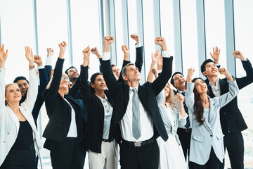 Wall Mural - Successful business people standing together showing strong relationship of worker community. A team of businessman and businesswoman expressing a strong group teamwork at the modern office. Jivy