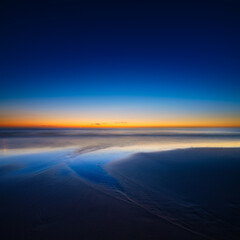 Wall Mural - a seascape during sunset. lines of sand on the seashore. bright sky during sunset. a sandy beach at 
