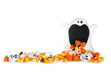 Wall Mural - Halloween ghost wide mouth bowl with spilling candy. Side view with long pile of treats isolated on a white background.