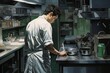 © Justin Eaton - Man's back in a Kitchen Working