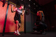 © Cassio Nunes - Personal trainer instructing student in barbell squats at gym