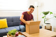 © AntonioDiaz - Cheerful man opening a mock-up box pacakage