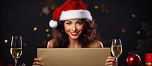 Woman In Red Dress And Santa Hat Holding Blank Gold Board With Champagne Christmas Sale And Gift Idea