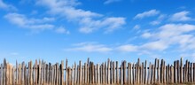 Stockade Fence Against The Blue Sky Pointed Logs Old Wood Texture