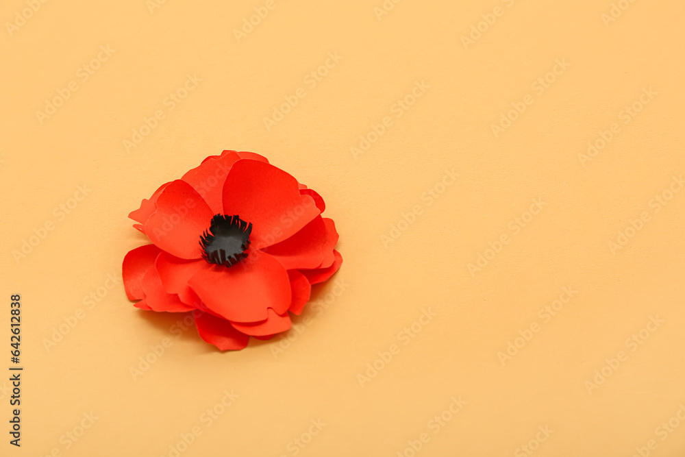 Red poppy flower on orange background. Remembrance Day in Canada