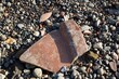 Broken clay pot on the stoney beach