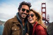 © Anne Schaum - Couple in their 30s smiling at the Golden Gate Bridge in San Francisco USA