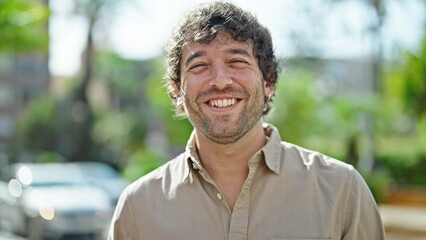 Canvas Print - Young hispanic man smiling confident speaking at park