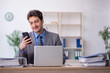 © Elnur - Young male employee working in the office