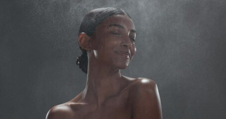 Wall Mural - Beauty, mockup and perfume with an indian woman in studio on a gray background for fresh fragrance. Luxury, wellness and smile with a young model spraying a product on her skin for cosmetic parfum