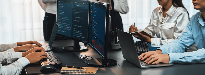 Wall Mural - software development team working together in office, coding script display on computer monitor. pro
