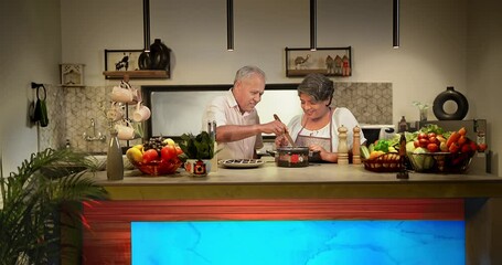 Wall Mural - Happy Indian Asian two aged love couple in modern kitchen enjoy fun joy care indoor home senior chef wife in apron teach old man male to stir mix fresh vegan soup food meal in pot using spatula spoon