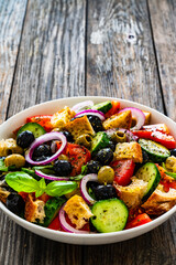 Panzanella salad on wooden table
