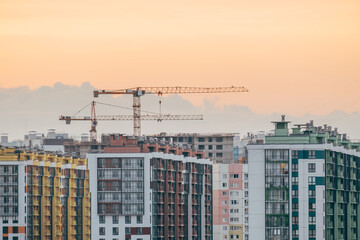 Cranes and building with evening sky background