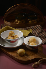 handmade mini bake luxury peranakan nonya pineapple paste tart cookies w clove stick in asian traditional rooster bowl wood plate on maroon background pastry dessert halal festive food cake shop menu