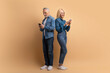 © Prostock-studio - Elderly couple use modern smartphones, reading text messages