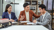 © Phushutter - Stress and consolation of Legal consultation, asian lawyers team meeting post-contract, contract finalization, contract review session, agreement assessment, legal experts in conversation